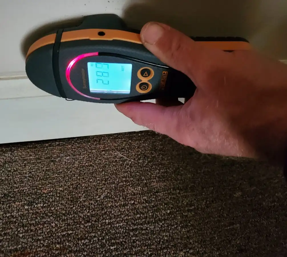Moisture detection at baseboard during Storm Damage Restoration in Thompson